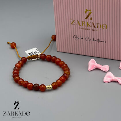 دستبند سنگی قهوه ای با مهره طلای بیضی