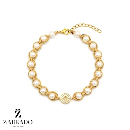 دستبند مروارید و بافت با نخ طلایی و پلاک قطب نما