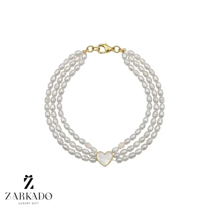 دستبند طلا با مروارید پرورشی و قلب میناکاری سفید